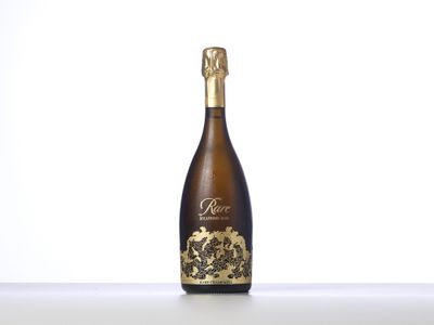 an empty bottle of wine sitting on top of a table
