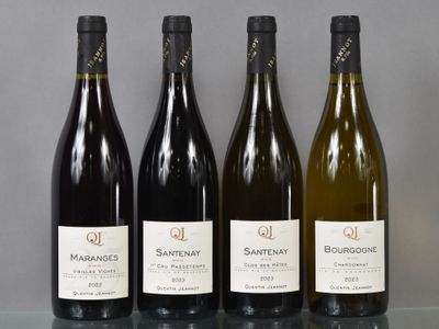 three bottles of wine are lined up on a glass table