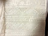 a white table cloth with a design on it