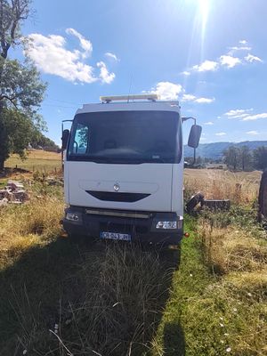 a white truck that is parked in the grass