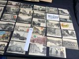 a lot of old photos on a table with a lot of them