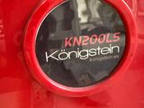 a close up of a red car with a sticker on it