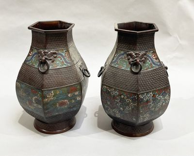two vases that are sitting on a white surface
