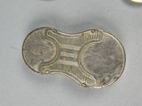 a coin and a pair of scissors sitting on a table