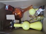 a box filled with assorted items including a lamp, a bottle, and other items