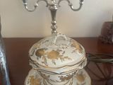 a table with a plate and a candle holder on it