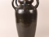a large brown vase with two handles on a white background