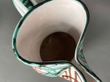 a cup that is sitting on a table with a spoon in it