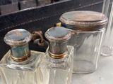 two bottles of perfume sitting next to each other on a table