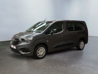 the grey van is parked in a room with a white wall