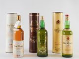 three bottles of different types of alcohol sitting next to each other