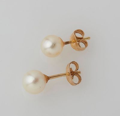 a pair of pearl and gold earrings