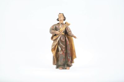 a statue of a woman holding a cross on a white surface