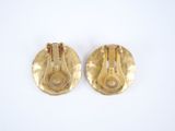 pair of vintage gold tone clip earrings with red stones