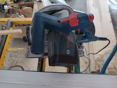 someone is using a circular saw to cut a piece of wood