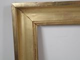 an image of a gold frame with a white wall in the background