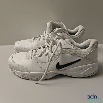 un gros plan sur une paire de chaussures blanches posées sur une table