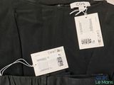 black pants with a price tag on a hanger on a hanger