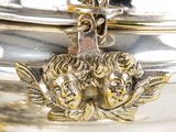a silver plate with a bird on top of it