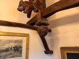 a picture of a room with a wooden ceiling and pictures on the wall