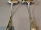 two spoons sitting next to each other on a table