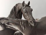 a statue of two horses that are standing next to each other