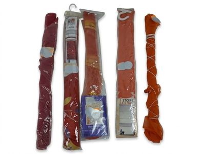 several different types of food wrapped in plastic bags on a white surface