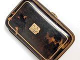 a small tortoise shell case on a white surface
