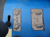 a person standing next to a blue trash can with drawings on it