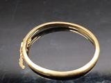 a gold ring with a chain around it