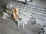 a man that is standing next to a bunch of metal beams