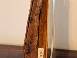 a small knife on a clear stand on a wooden table