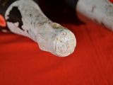 a close up of a bottle of wine on a red cloth