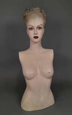 a female mannequin with a very large breast on display