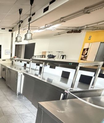 a large kitchen with stainless steel appliances and counters
