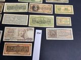 several different types of paper money are displayed on a table