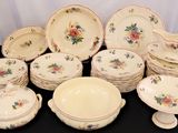 a lot of plates and bowls on the table