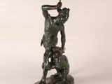bronze statue of a man with a dog on a white background