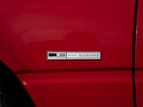 a close up of a red car with a badge on it