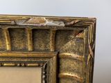 an antique gold picture frame with a picture in it