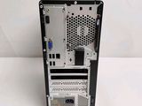 a small computer on a white surface with a white background