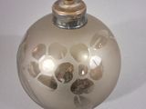 a small glass bottle with a gold decoration on it