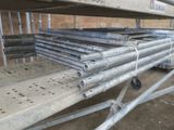 a pile of steel pipes sitting on top of a metal rack