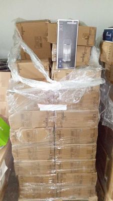 a stack of boxes with a cell phone on top of it