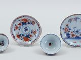 several pieces of chinese porcelain are displayed on a white surface