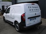 a white van that is parked in front of a building