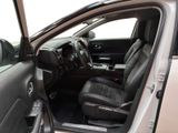 the interior of a car with the door open and the driver ' s seat down