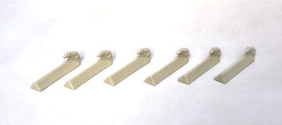 five pieces of white plastic on a white surface