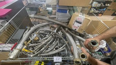 a man that is holding a hose in a shopping cart