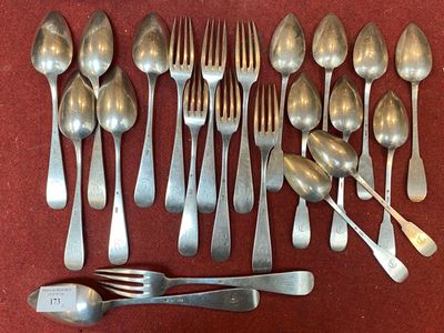 a lot of spoons and forks laid out on a table